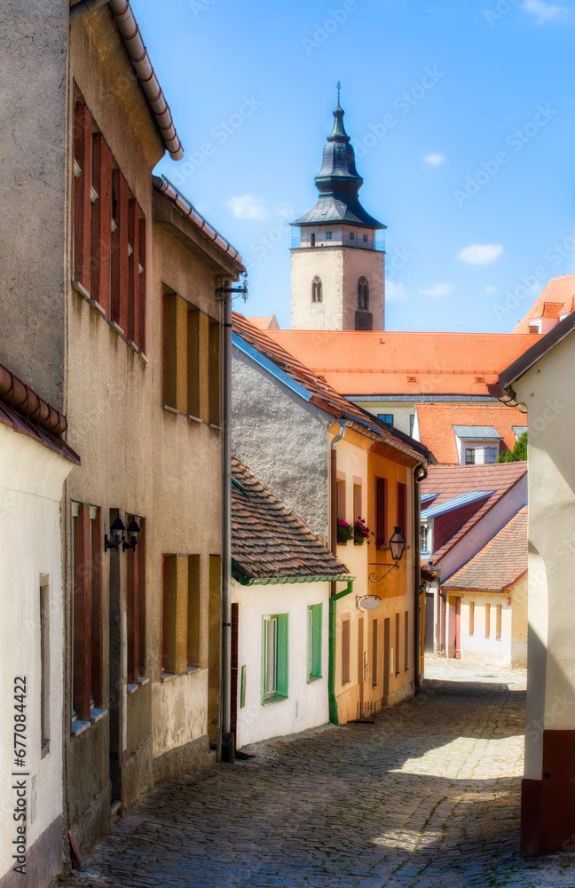 Narrow, Cobbled Street in Telc in the Czech Republic, with the Towers of the Church of St James