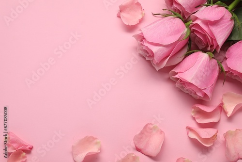 Fototapeta Naklejka Na Ścianę i Meble -  Beautiful roses and petals on pink background, flat lay. Space for text