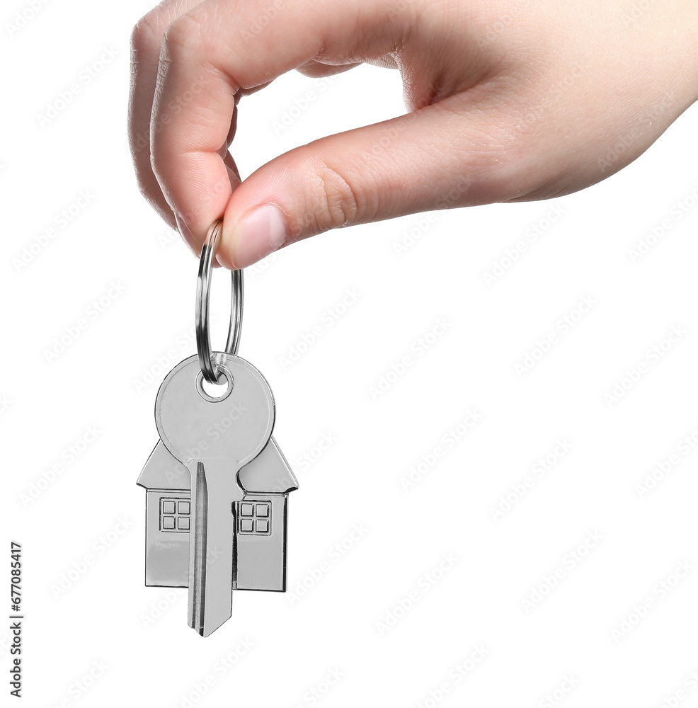 Woman holding key with keychain in shape of house isolated on white, closeup Woman holding key with keychain in shape of house isolated on white, closeup