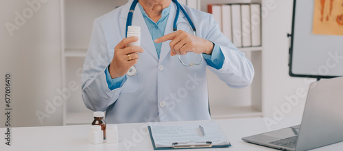 Doctor giving hope. Close up shot of young female physician leaning forward to smiling elderly lady patient holding her hand in palms. Woman caretaker in white coat supporting encouraging old person