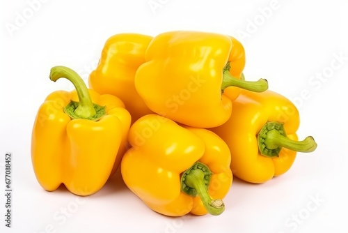 a bunch of yellow paprikas on a white background photo
