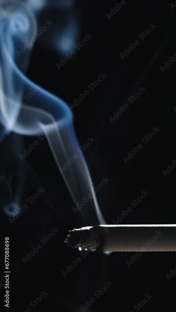 Cigarette smoking closeup isolated on black background Cigarette smoking closeup isolated on black background