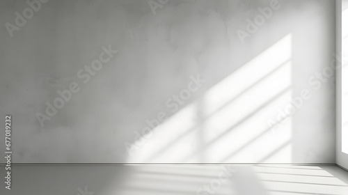 Minimal abstract light gray background for product presentation. Shadow and light from windows on plaster wall.