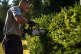 Generative AI : man hand with hedge trimmer cutting bushes of white cedar to ideal fence. 