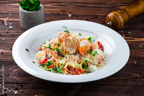 Italian cuisine Caesar salad with salmon  parmesan cheese  quail eggs  lettuce  tomatoes and croutons.