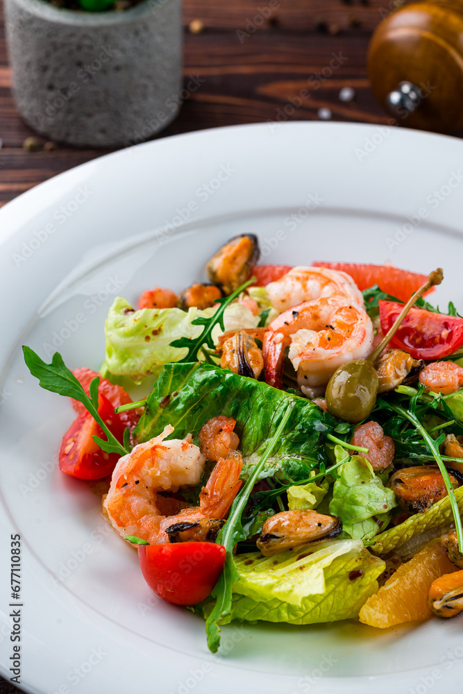 Fresh green salad of shrimp, mussels, cherry tomatoes oranges, grapefruits, capers, lettuce and arugula.