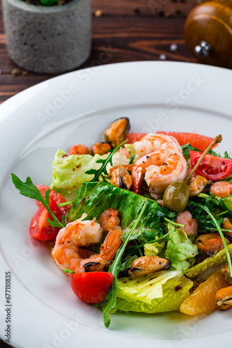 Fresh green salad of shrimp, mussels, cherry tomatoes oranges, grapefruits, capers, lettuce and arugula.