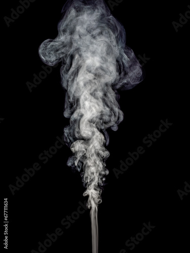 Fluffy wisp of white smoke isolated on black background and rising up