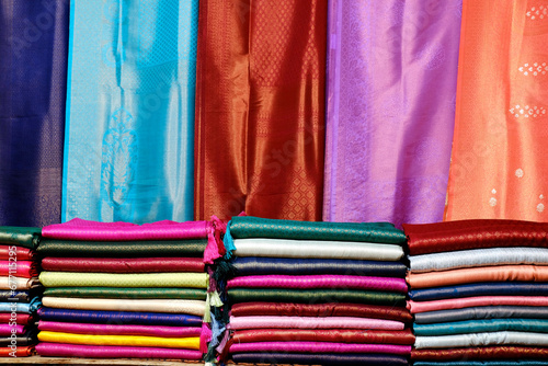 Fancy Indian sarees, Neatly stacked colorful silk saris in racks in a textile shop. Incredible India.