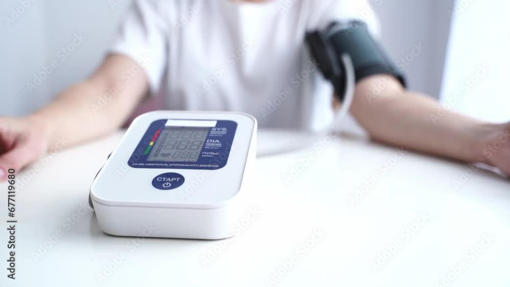 the girl measures blood pressure with a tonometer the girl measures blood pressure with a tonometer