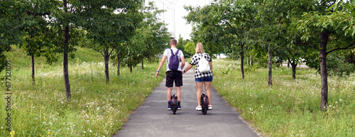 Man and woman riding electric unicycles photo