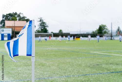 Flag located on the soccer field that indicates where the corner kick is taken in a game. Selective focus.