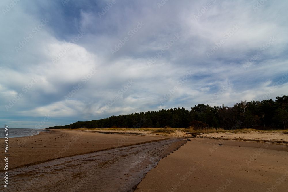 Sandy baltic beach with river