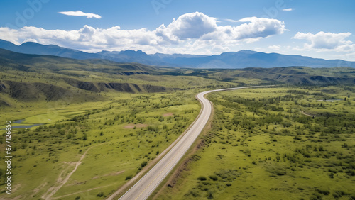 An empty road in an endless grassland seen from a drone