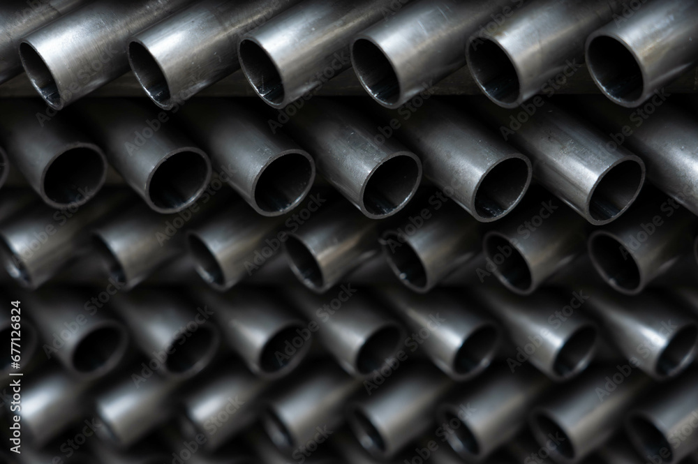 Stack of steel pipes. Close - up of stack of metal pipes. Industrial elements closeup. Parts stacked for further processing. Stack of steel pipes. Close - up of stack of metal pipes. Industrial elements closeup. Parts stacked for further processing.