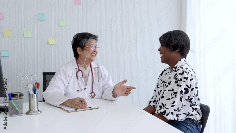 Elderly senior women doctor giving a consulting to a mix African-American women. Healthy middle age women listening the doctor advice for annual health check up. Elderly senior women doctor giving a consulting to a mix African-American women. Healthy middle age women listening the doctor advice for annual health check up.