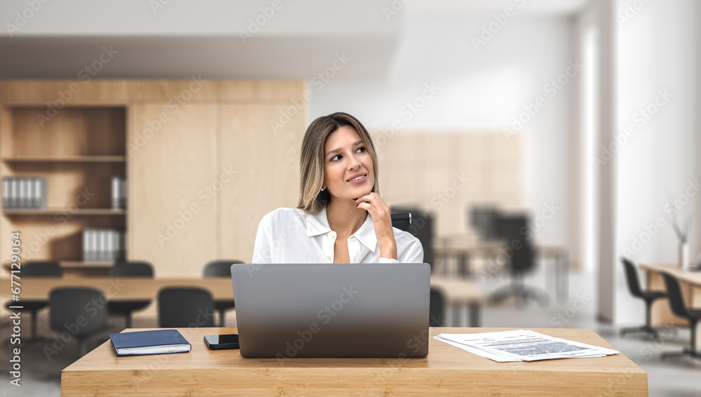 Pensive woman with laptop sitting at office desk Pensive woman with laptop sitting at office desk