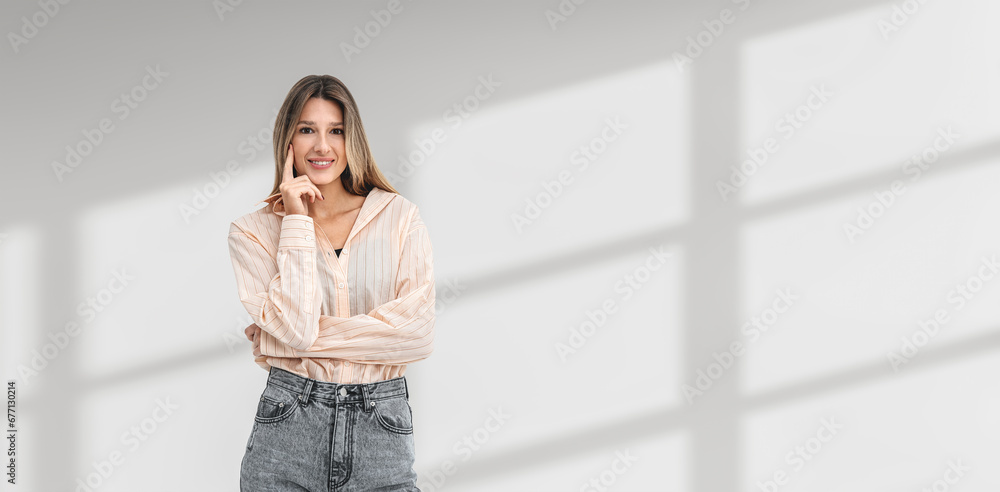 Pensive cheerful young woman student