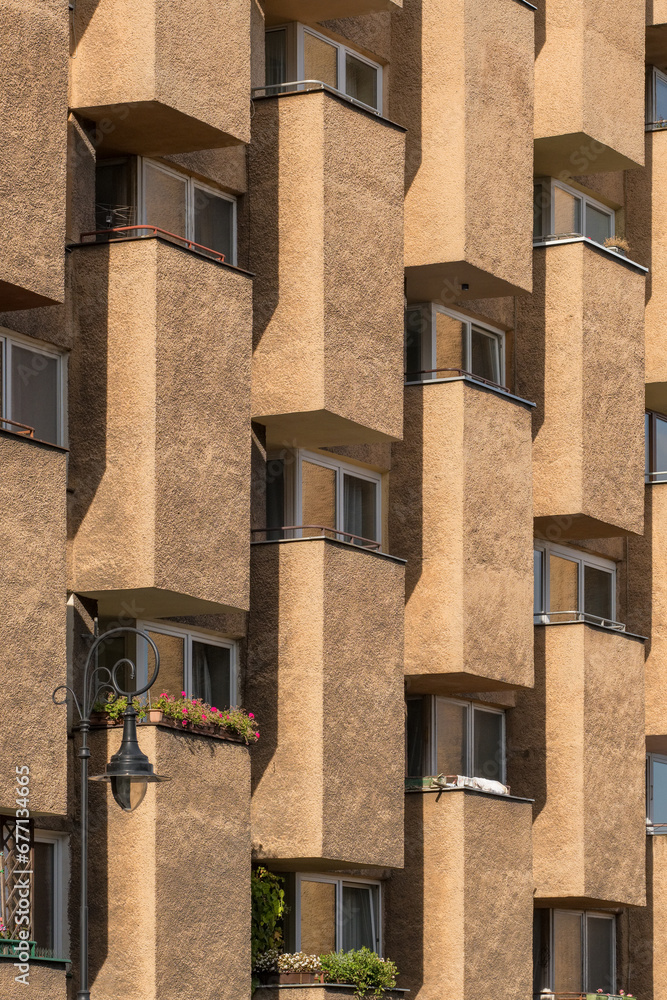 Fototapeta premium Fragment of a concrete building with windows and balconies in Warsaw, Poland