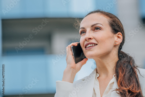 portrait of businesswoman talking on mobile phone on the street