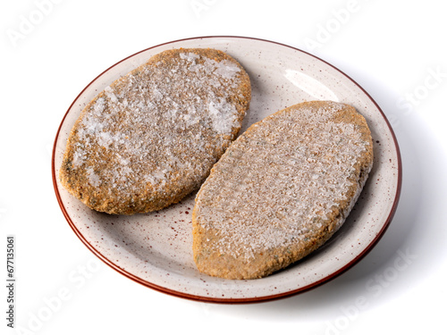 Frozen cutlets on a plate isolated on a white background