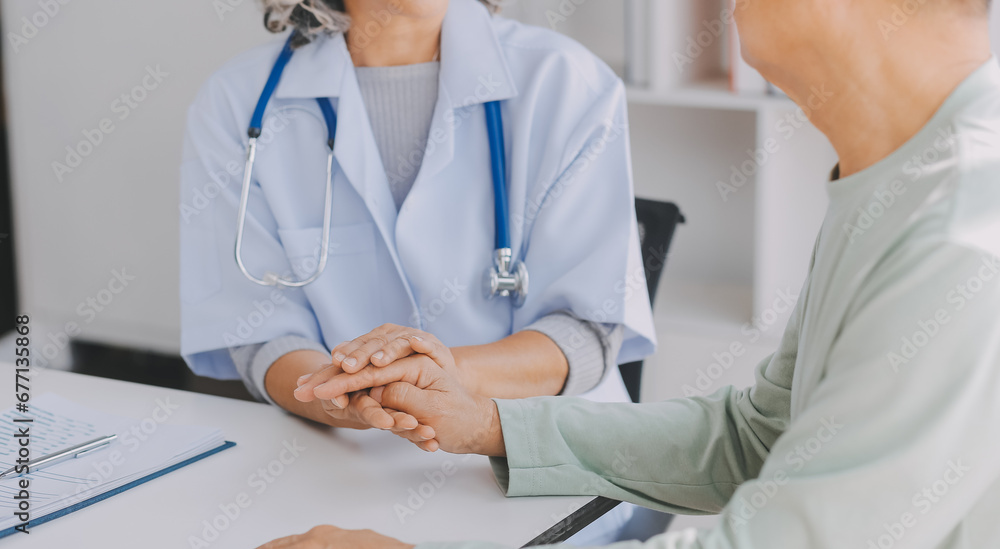 Mature Asian male doctor talking with his patient, explaining the procedure to old lady. Mature Asian male doctor talking with his patient, explaining the procedure to old lady.