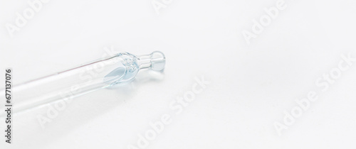 Cosmetic pipette with blue and blue gel, serum, serum on a light background.