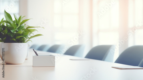 Bright modern boardroom with plant and empty chairs photo