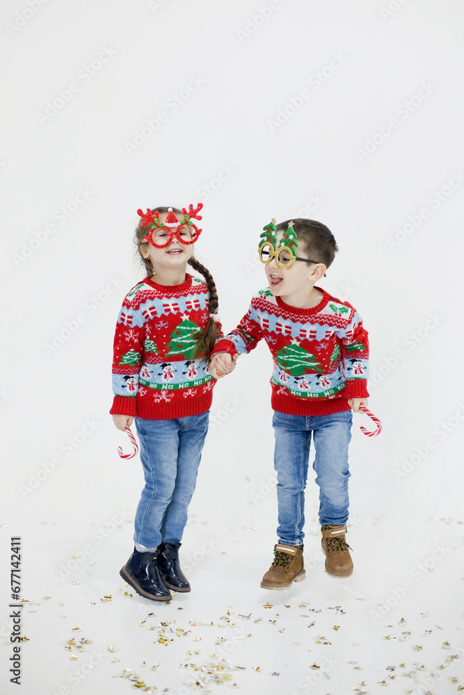 Preschool boy, girl in Christmas sweaters Preschool boy, girl in Christmas sweaters
