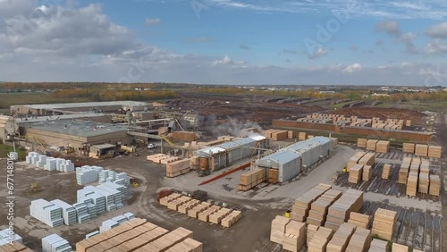 Aerial video of lumber yard and sawmill in Alberta, Canada on an autumn day