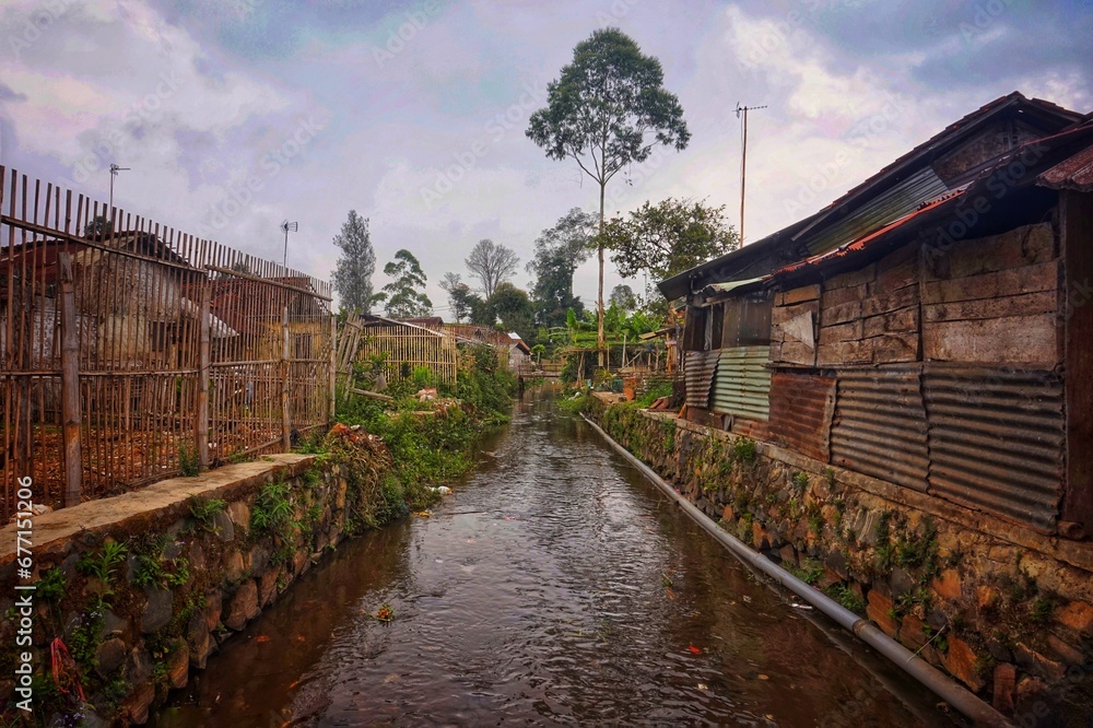 The dirty and smelly river in the village functions as an antidote to flooding 