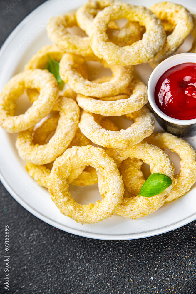 onion rings fast food deep fryer batter tomato sauceeating cooking appetizer meal food snack on the table copy space food background rustic top view onion rings fast food deep fryer batter tomato sauceeating cooking appetizer meal food snack on the table copy space food background rustic top view