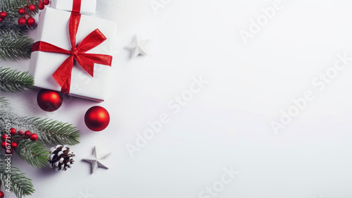 Christmas background. White gift box with red ribbon and christmas decoration on white background.