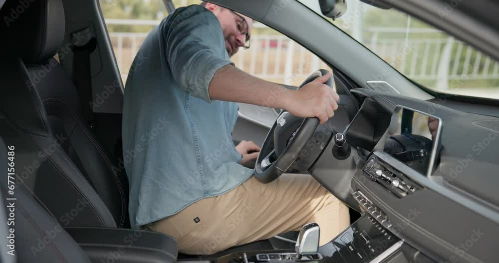 man gets in a car and sits behind steering wheel wheel man gets in a car and sits behind steering wheel wheel