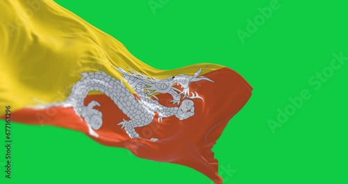 National flag of Bhutan waving in the wind on green screen photo