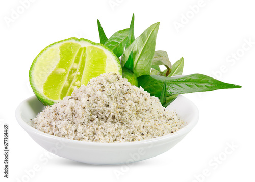 Mixture of ground black peppercorns and salt in a white ceramic bowl with a lime slice and Vietnamese coriander leaves