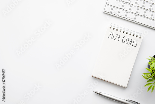Notebook with 2024 goals text on it to apply new year resolutions and plan. photo