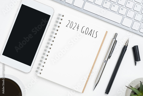 Notebook with 2024 goals text on it to apply new year resolutions and plan.