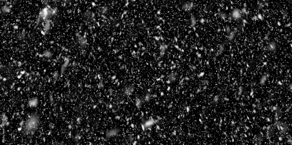 white flakes is surrounding randomly on black background, winter morning snow flakes are dancing in the air, white glitter background for presentation.