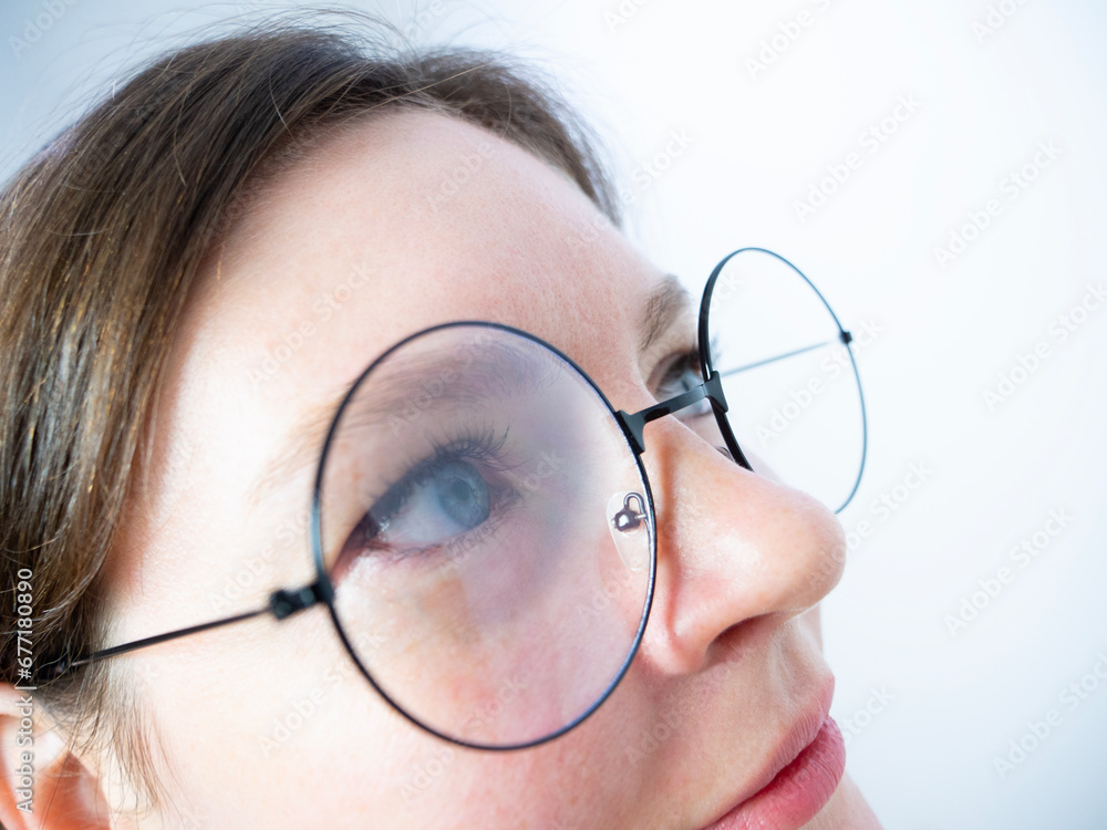 woman with eyeglasses looking up extreme close up, curiosity concept woman with eyeglasses looking up extreme close up, curiosity concept