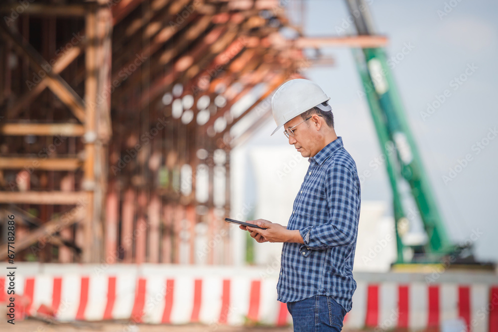 Engineer man with digital tablet checking project at infrastructure construction site, Foreman worker at the building site Engineer man with digital tablet checking project at infrastructure construction site, Foreman worker at the building site