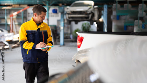 Accident Inspector Inspect damage car caused by car crash on the road. Car insurance agent examining car by Claim form clipboard in garage. Motor insurance