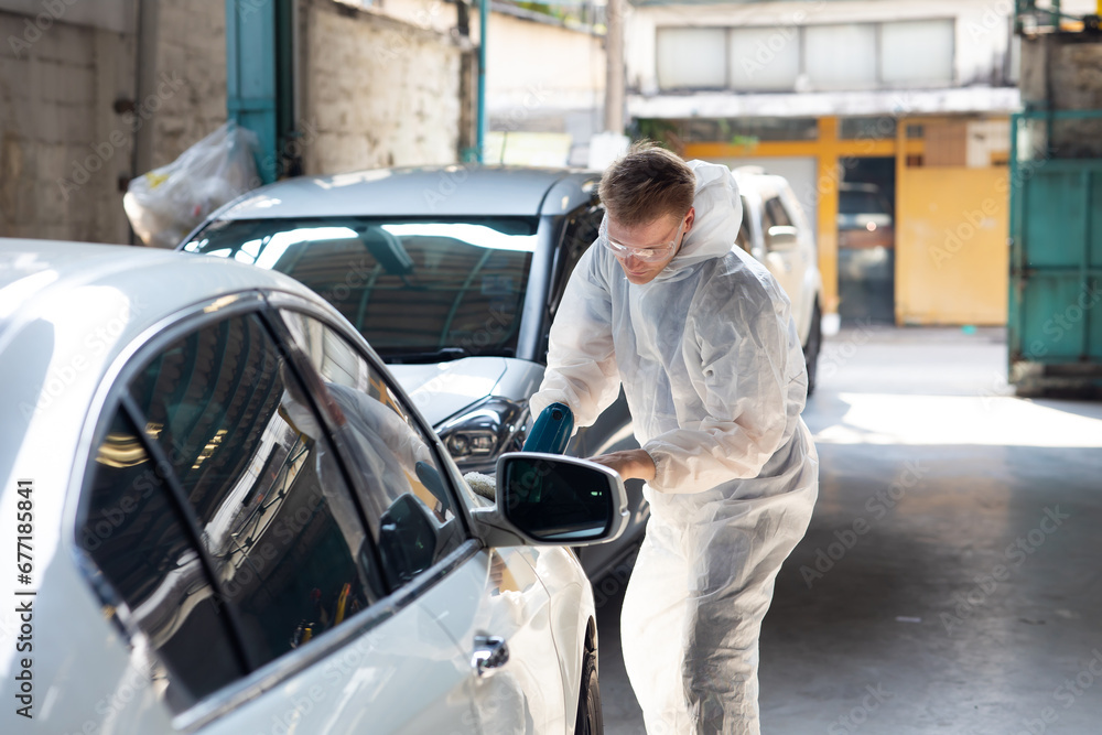 Hands with orbital polisher. Car polishing waxing. Auto mechanic car man worker working painting in car paint chamber. Body paint garage Hands with orbital polisher. Car polishing waxing. Auto mechanic car man worker working painting in car paint chamber. Body paint garage