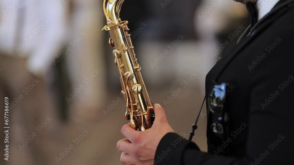 Saxophonist musician playing saxophone or sax at the concert or party. Saxophonist live performance. Saxophonist play on golden saxophone, close up. Jazz music. horizontal orientation video Saxophonist musician playing saxophone or sax at the concert or party. Saxophonist live performance. Saxophonist play on golden saxophone, close up. Jazz music. horizontal orientation video