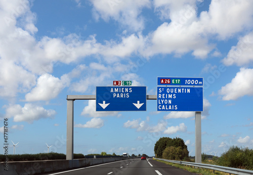 large road sign with the French places to reach the city of Paris or Amiens photo