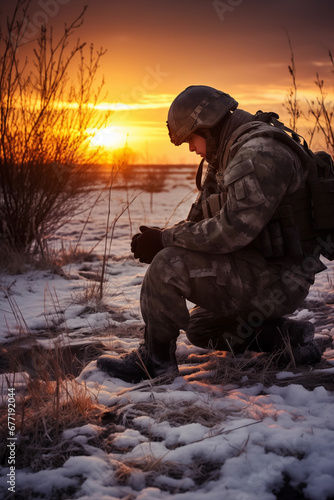 Photograph of a soldier kneeling after praying at sunrise. © jkjeffrey