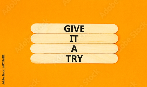 Give it a try symbol. Concept word Give it a try on beautiful wooden stick. Beautiful orange table orange background. Business give it a try concept. Copy space.