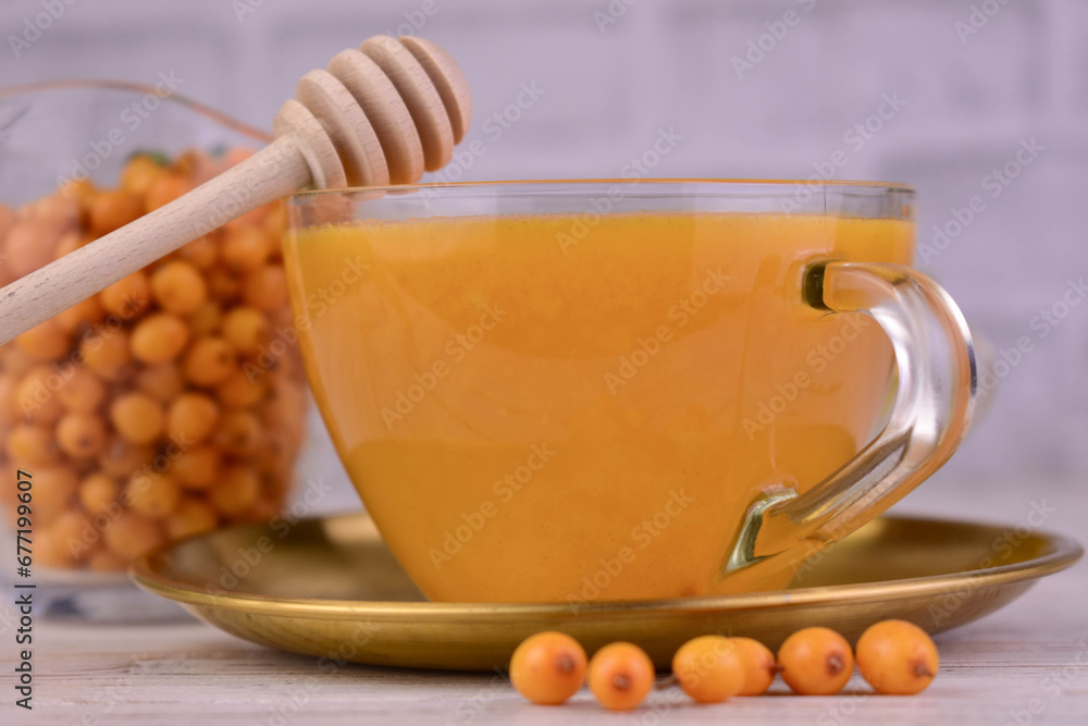 Tea from sea buckthorn berries in a cup. Close-up. Tea from sea buckthorn berries in a cup. Close-up.