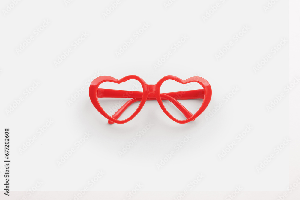 Red heart shaped sunglasses on white background Red heart shaped sunglasses on white background