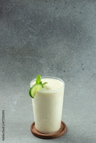 ayran drink with mint and cucumber on a white background, clean eating for weight loss. place for text